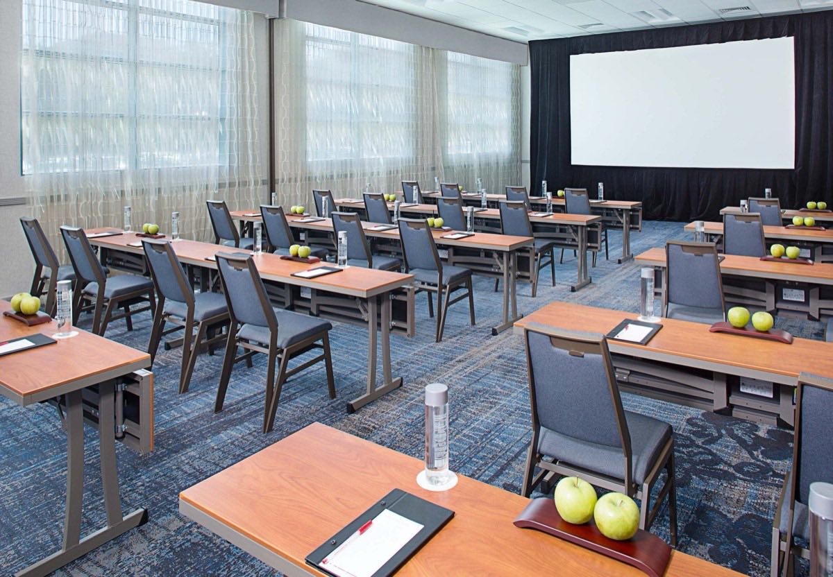 Breakout room in classroom set with notepads and green apples